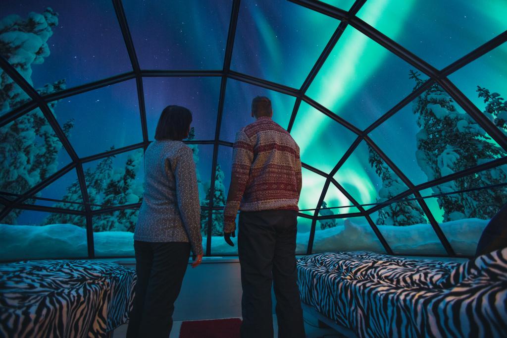 Kakslauttanen glass igloo inside Northern Lights