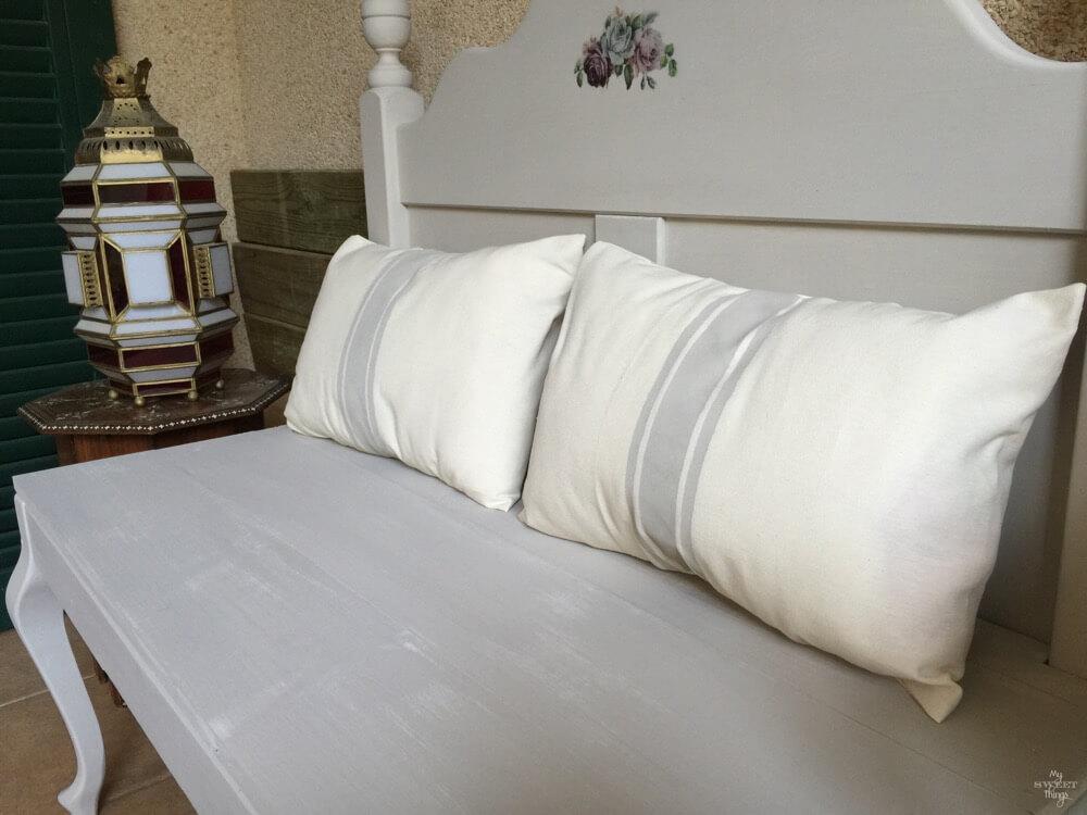 How to repurpose a headboard into a bench and make it French style with a graphic and some grain sack style pillows