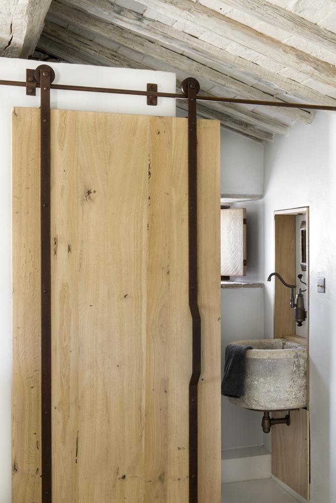 Detalle de la puerta corredera que da al baño del dormitorio principal de la villa en la Toscana