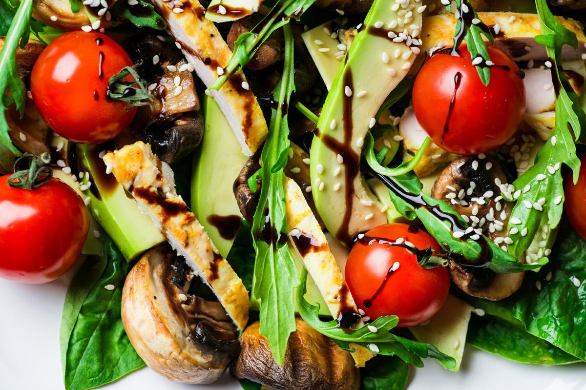 Chicken salad with avocado, tomatoes cherry, mushrooms and spinach