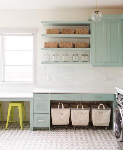 Ashley Winn Design -Fantastic laundry room features gray green cabinets