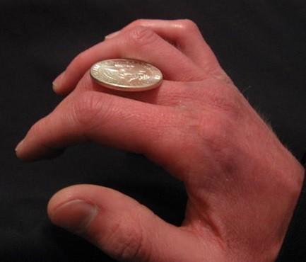 pasar moneda entre los dedos de mano