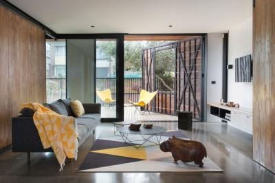 Cozy-Stonewood-Home-Living-Room-Interior-Design-Furnished-with-a-Gray-Sofa-Round-Coffee-Table-and-Cute-Sculptural-Rhino-Statue