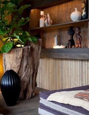 Impressive-Wall-Decoration-Design-in-Terrace-House-with-Brown-Colored-Shelves-which-are-Made-from-Wooden-Material-and-Several-Wooden-Sculptures-There-936x1367