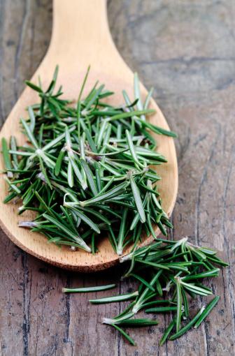 Close-up of fresh rosemary on wooden spoon