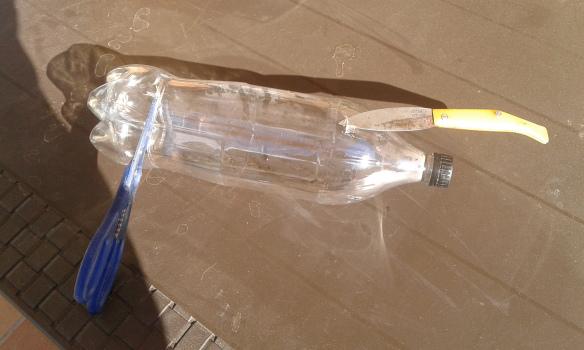 Cortar base de la botella y hacer agujeros de drenaje