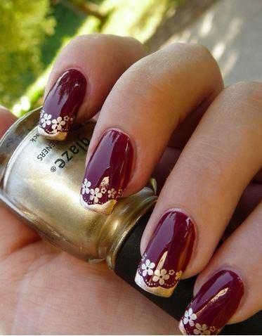 uñas rojas con flores doradas