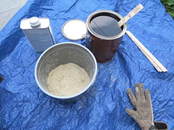 It was also necessary to grout and fill in all the voids on the floor. She mixed up a creation of fine saw dust, gloss oil based polyurethane, and mineral spirits to thin