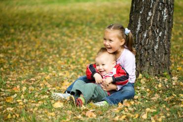 Cute children are playing in autumn park