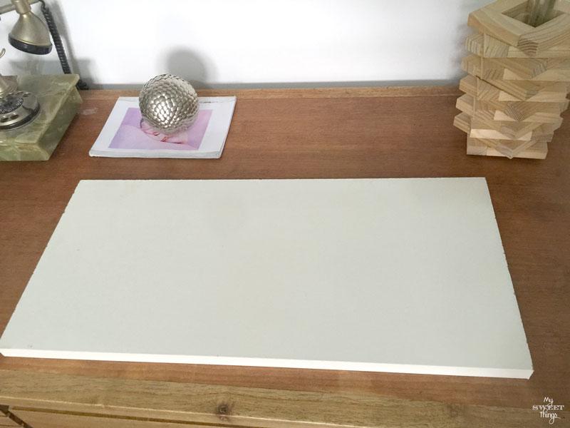 How to make an cool string wall art as a DIY birthday gift using a piece of scrap wood, some yarn and head nails