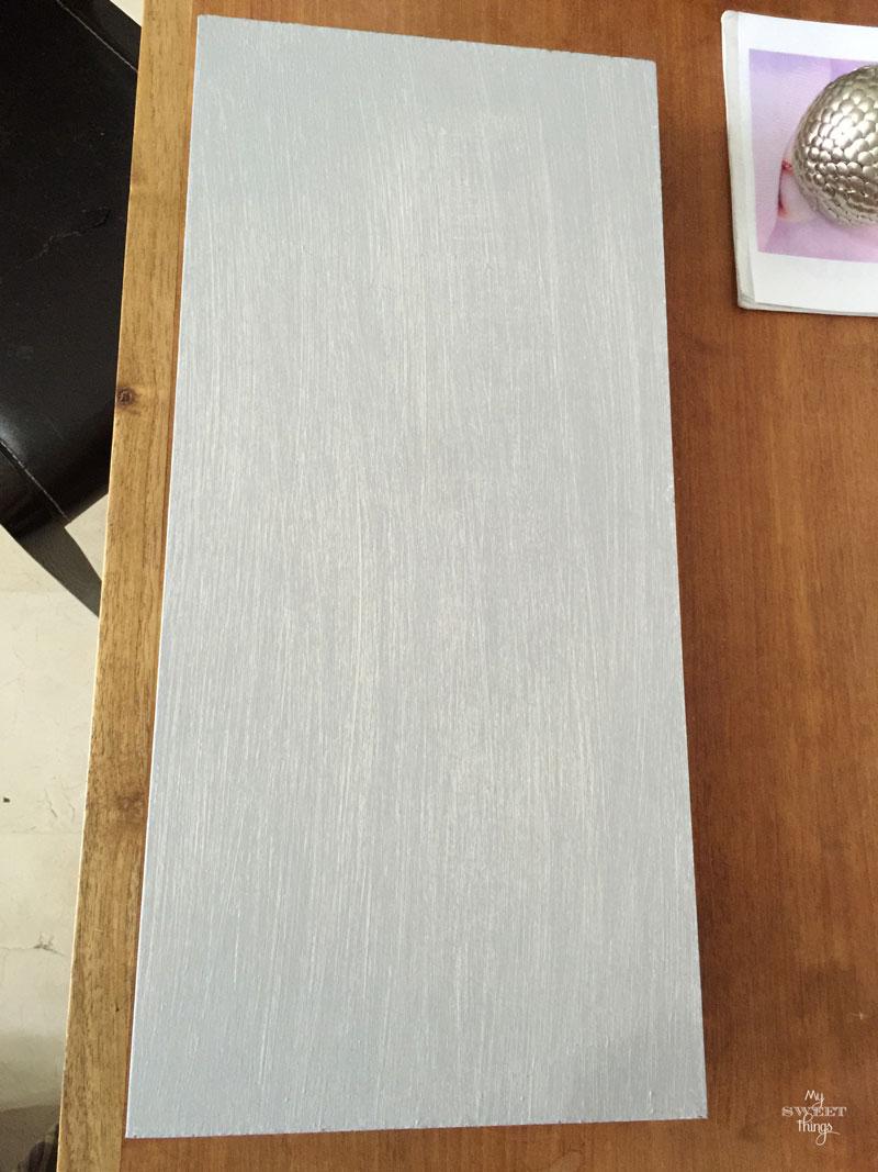 How to make an cool string wall art as a DIY birthday gift using a piece of scrap wood, some yarn and head nails