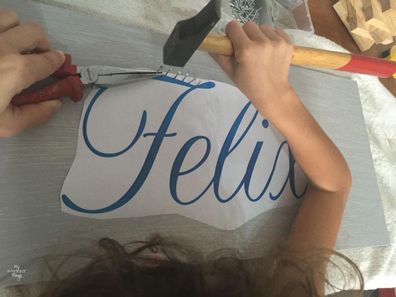 How to make an cool string wall art as a DIY birthday gift using a piece of scrap wood, some yarn and head nails