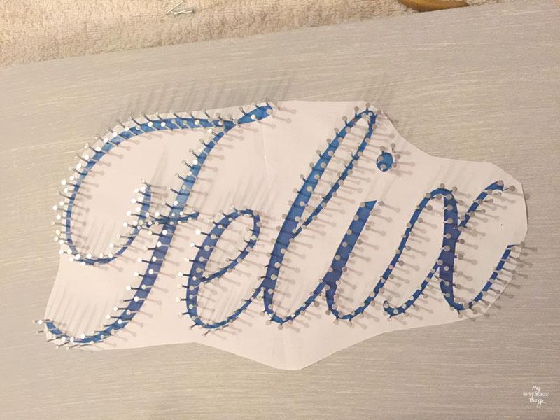 How to make an cool string wall art as a DIY birthday gift using a piece of scrap wood, some yarn and head nails