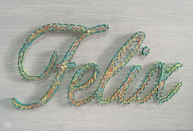How to make an cool string wall art as a DIY birthday gift using a piece of scrap wood, some yarn and head nails