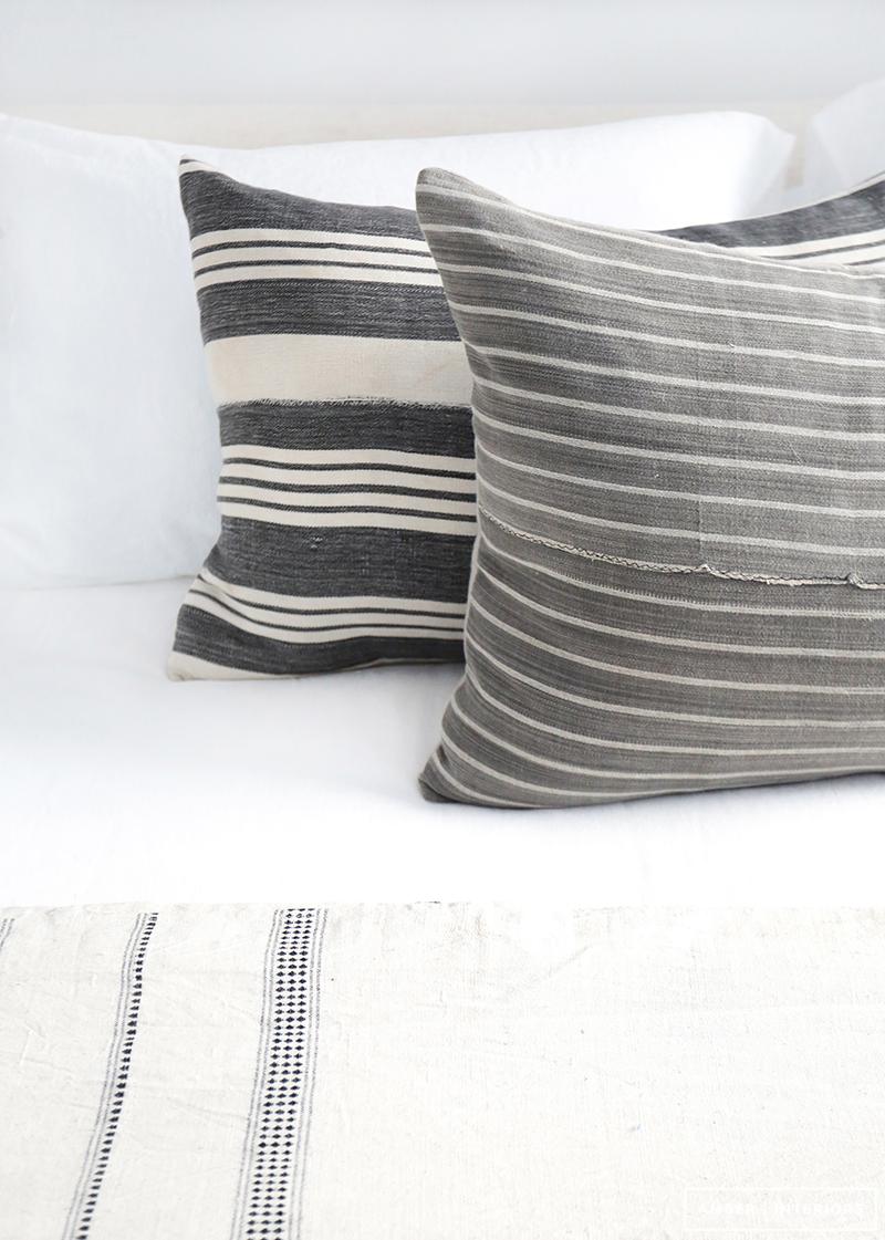 Detalles, cojines de rayas y sábanas lisas