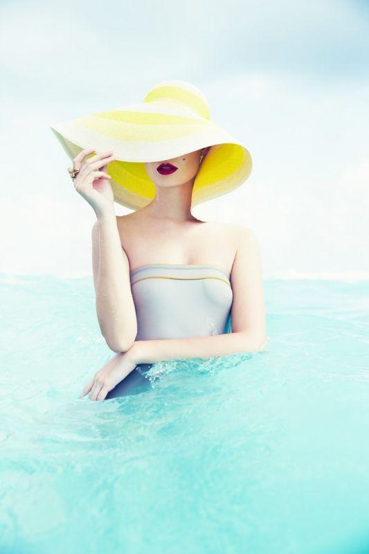 2. Woman in a yellow straw hat in the sea