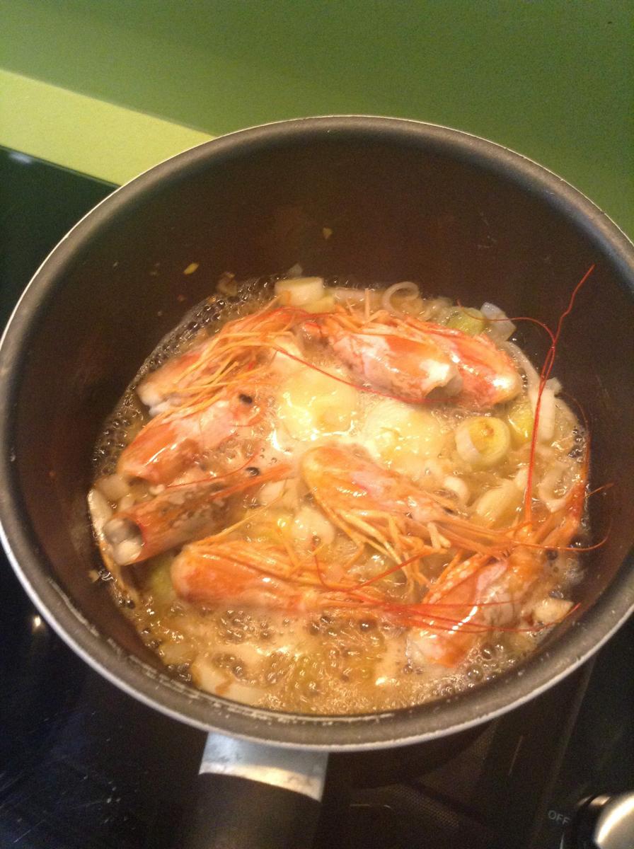 Añadimos las cabezas de gamba, coñac y agua.