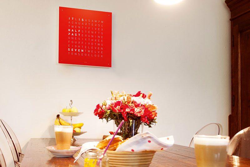 reloj de pared qlocktwo colgado en pared