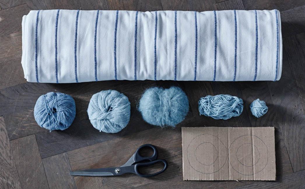 alfombra con pompones de lana