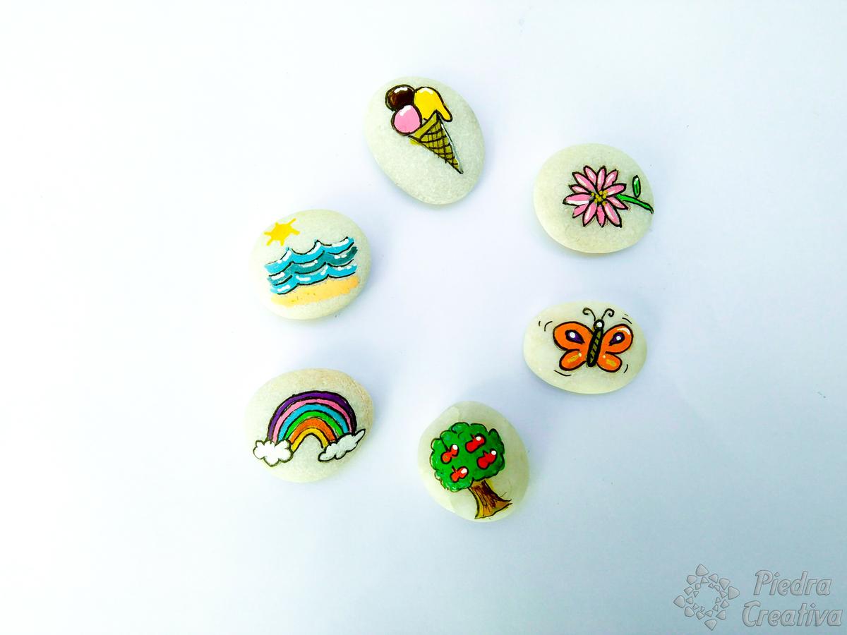 Piedras pintadas perfiladas del juego 4 estaciones