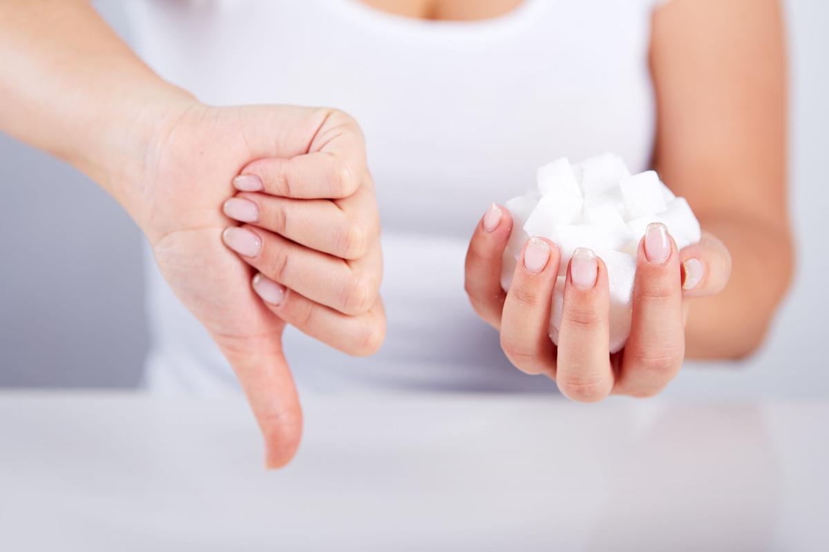 38744866 - woman holds in hand of sugar cubes