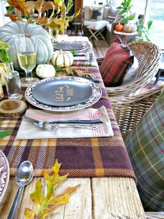 Gorgeous outdoor table setting for fall/autumn, featuring plaid blankets and other rustic accents.