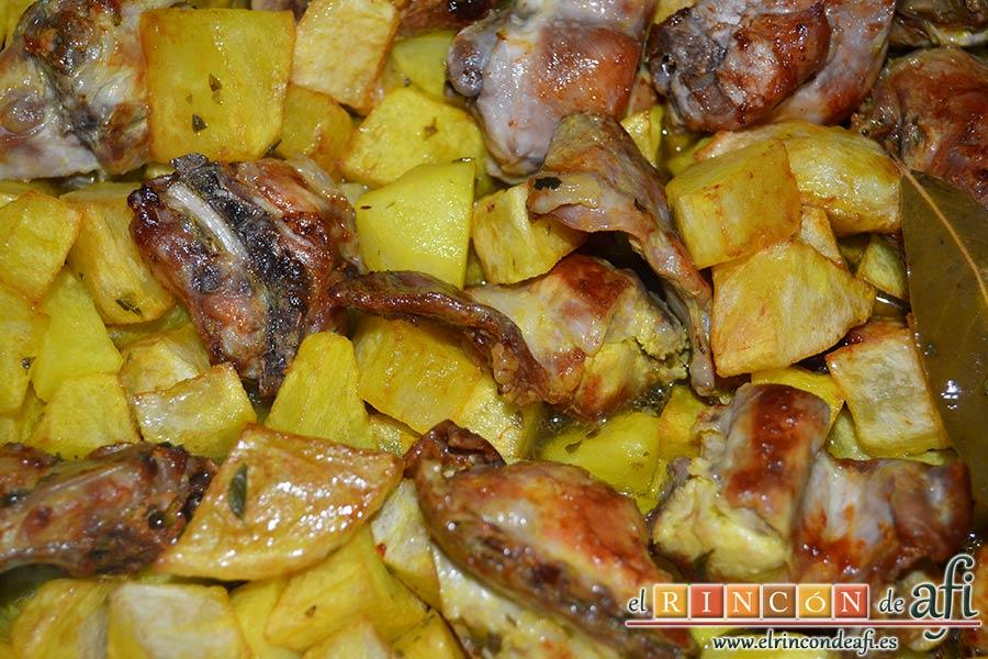 Conejo estilo Afi, cuando esté todo frito y reservado verter en el caldero la cabeza de ajos, la mitad del aceite de la fritura del conejo y el caldo