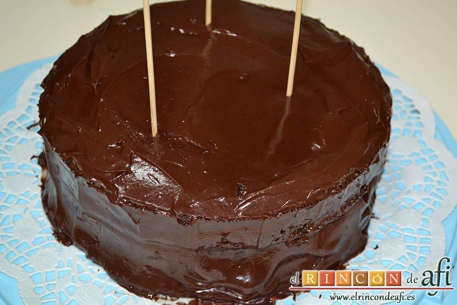 Pastel del diablo, cubrirlo todo de ganache y fijarlo con unos palos de madera para que no se caiga al transportarlo