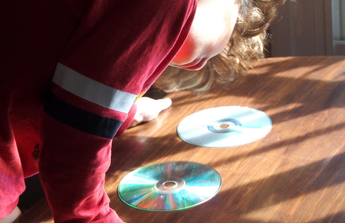 Nico observando la luz y los reflejos en los Cds