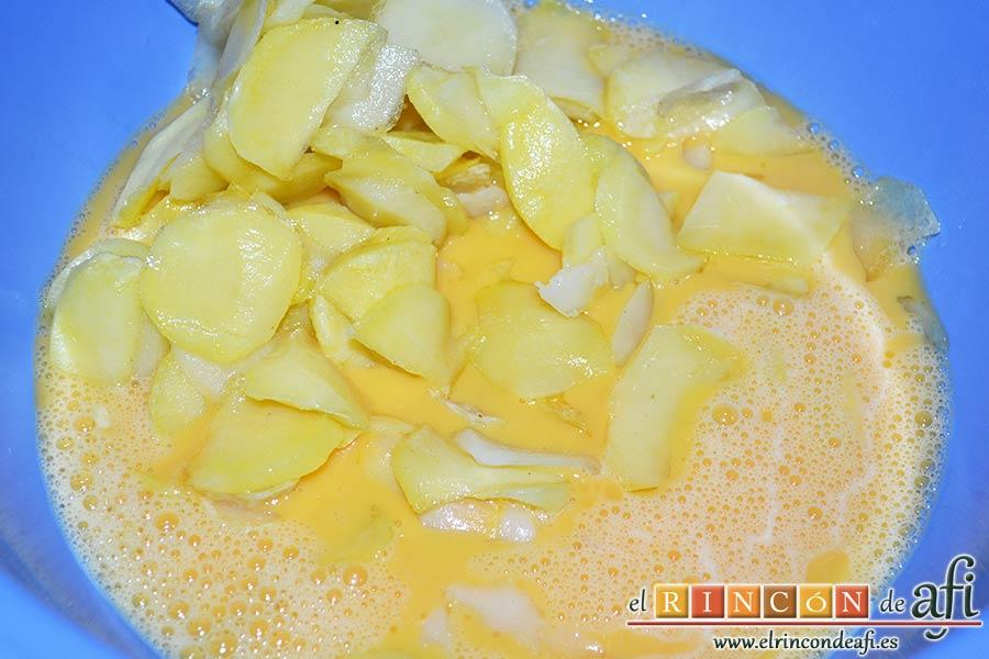 Tortilla de bacalao y puerros, freír las papas y añadirlas al bol de los huevos batidos