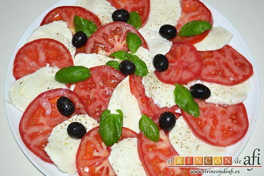 Ensalada caprese, salpimentar y colocar las aceitunas negras