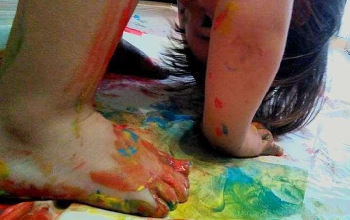 Niño pintando con las manos. Portada del grupo jugar en casa