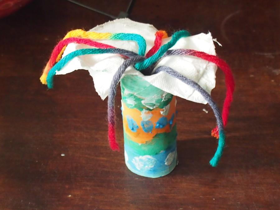 Difusor casero DIY hecho con un rollo de papel higiénico, papel y unos trozos de lana de colores. En vez de sahumerio quemado se usa este difusor