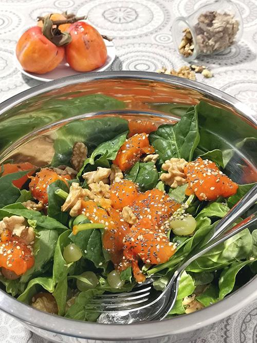 Ensalada de espinacas con caqui, nueces y uva - plano cenital