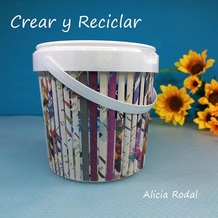 En este tutorial veremos cómo decorar un envase en forma de pote o cesta plástica, con papel periódico o revistas viejas para conseguir un efecto como de madera. Es la decoración de un recipiente, tarro o tarrina de helado o yogur, haciendo la imitación de tablas o palos de madera. DIY