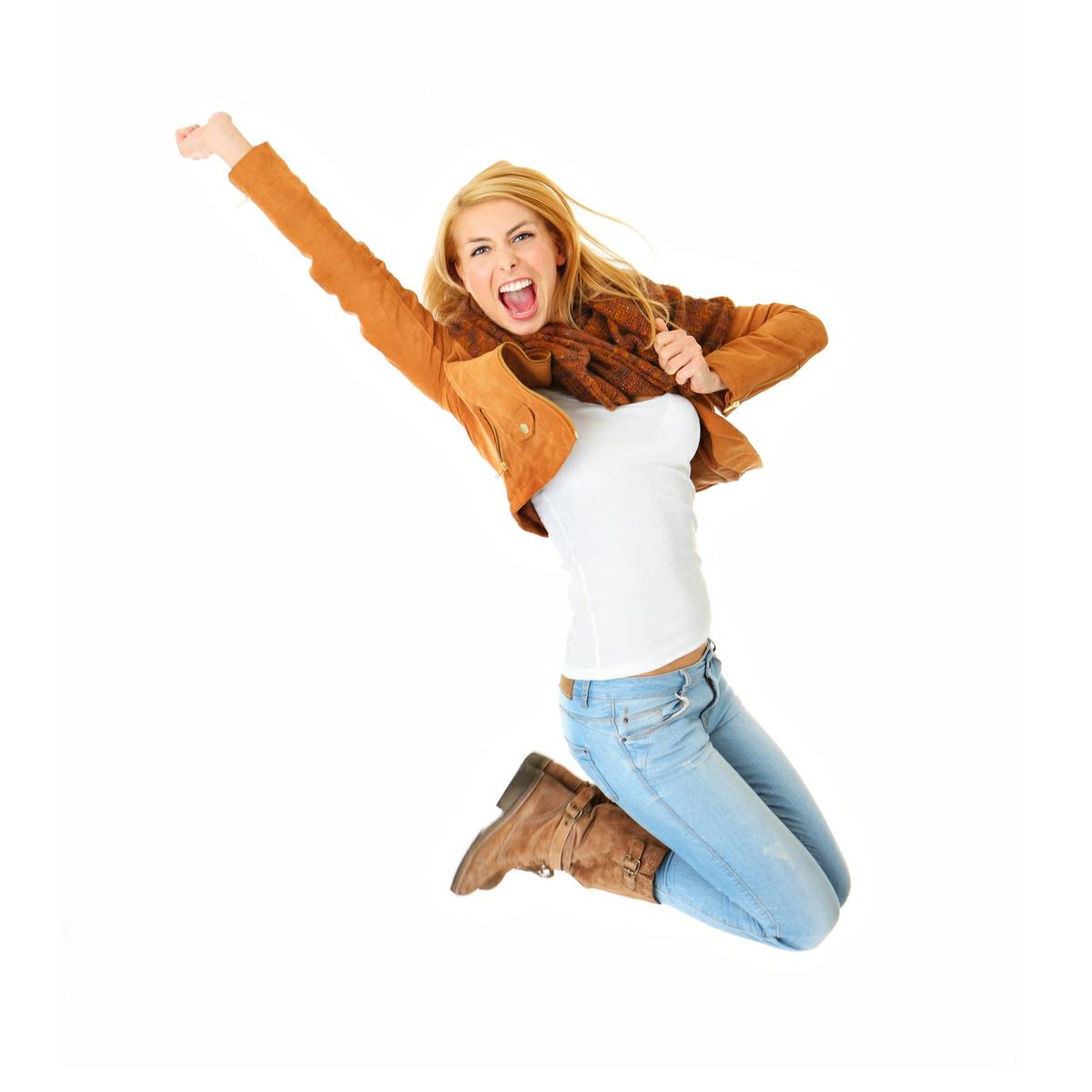 A picture of a young happy woman jumping with joy over white background
