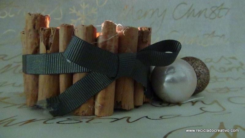 Portavelas con ramitas de canela, reciclando latas de atún