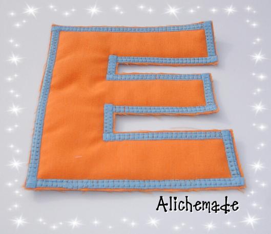 Letra de tela reversible, E.