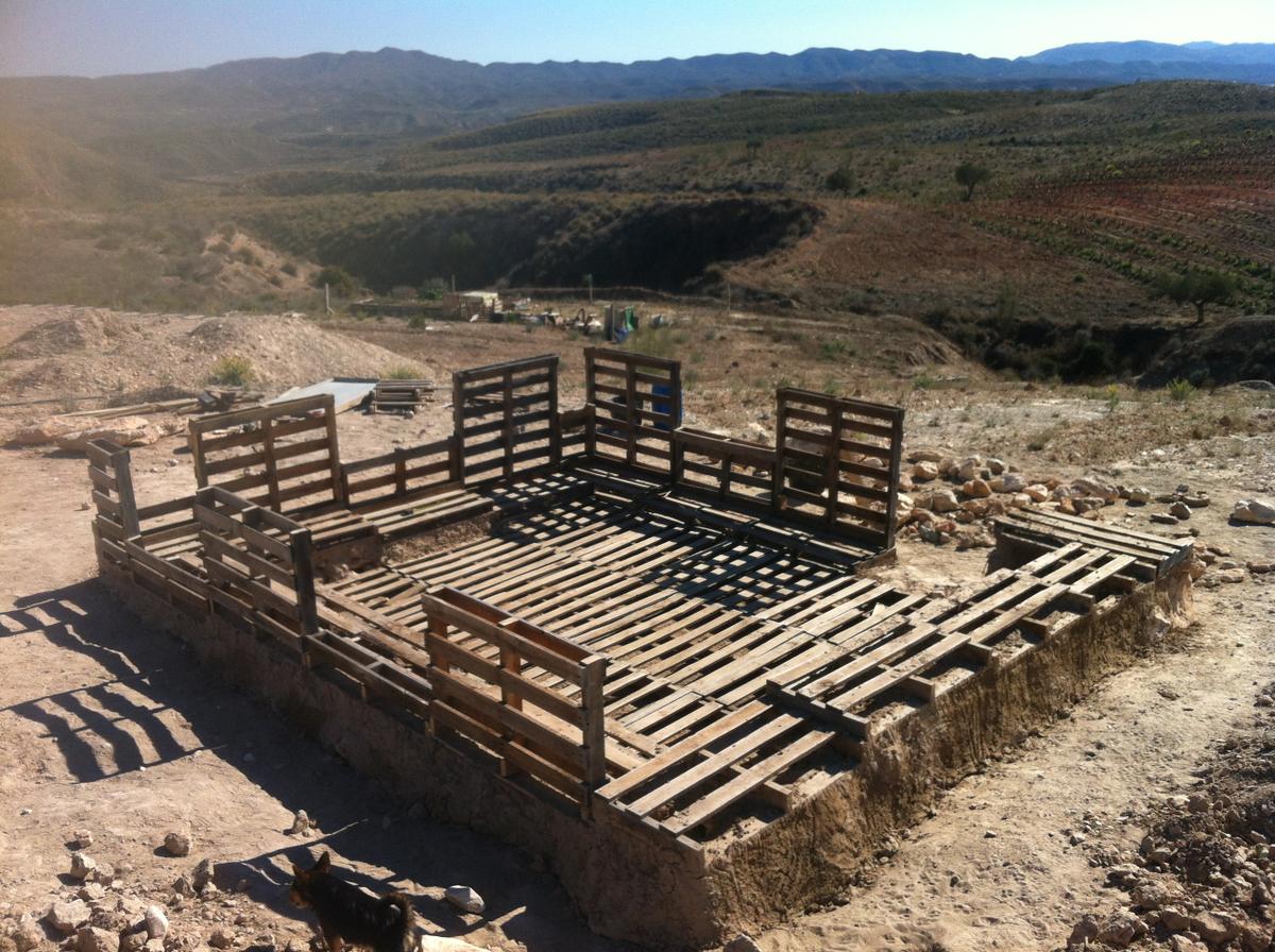 Bioconstrucción con palets, piedras y barro.